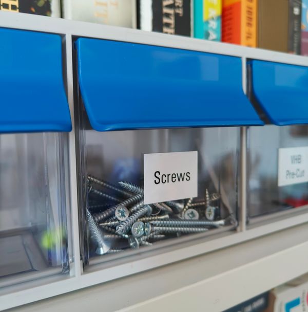 Storage bins labeled for organizing small parts and hardware Storage bins labeled for organizing small parts and hardware