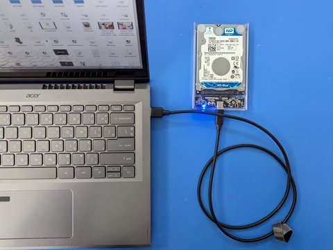 External storage device connected to a laptop through a USB-C cable External storage device connected to a laptop through a USB-C cable