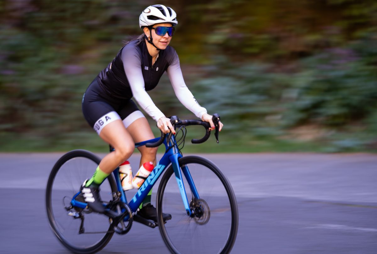 Cyclist riding a road bike outdoors while tracking a ride with a GPS computer Cyclist riding a road bike outdoors while tracking a ride with a GPS computer