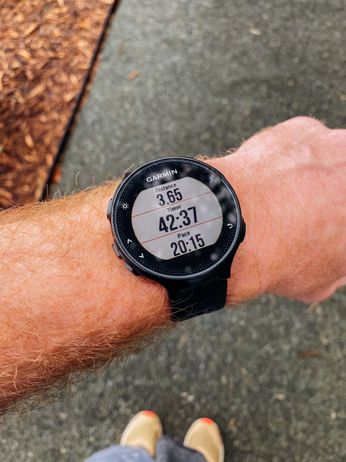 Close-up of a Garmin sport watch worn on the wrist showing distance and pace data Close-up of a Garmin sport watch worn on the wrist showing distance and pace data