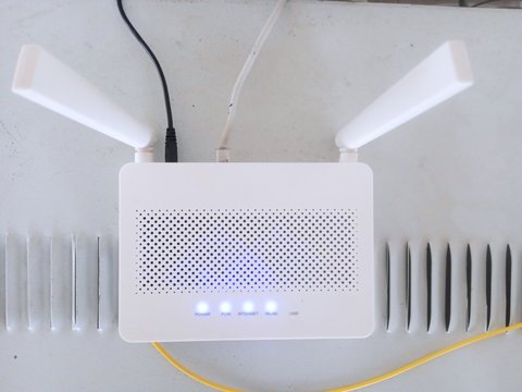 Wireless router with antennas connected to network and power cables at home Wireless router with antennas connected to network and power cables at home