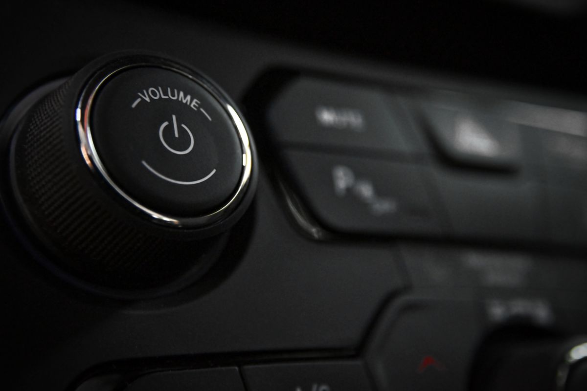 Close up of car stereo volume knob and control buttons on dashboard Close up of car stereo volume knob and control buttons on dashboard