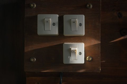 Row of standard wall light switches similar to where a Decora Smart switch is installed in a home Row of standard wall light switches similar to where a Decora Smart switch is installed in a home