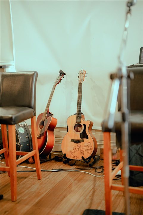 Acoustic guitars set up in a recording studio alongside effects processing gear Acoustic guitars set up in a recording studio alongside effects processing gear