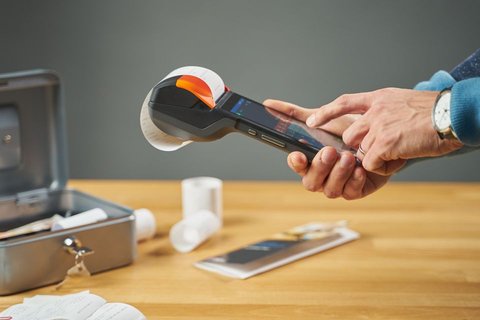 Hand operating a portable receipt printer similar to a BIXOLON POS printer Hand operating a portable receipt printer similar to a BIXOLON POS printer