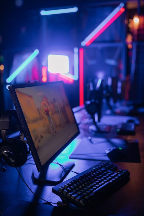 RGB lit streaming desk setup showing a DAW control surface style production rig