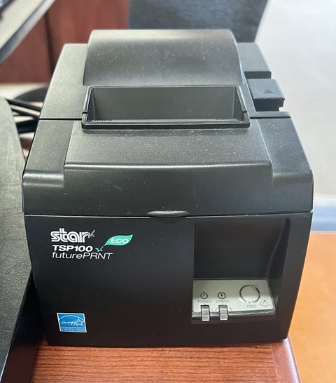 Star Micronics thermal receipt printer used at a point-of-sale checkout station Star Micronics thermal receipt printer used at a point-of-sale checkout station