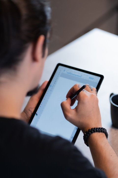 Digital artist sketching with a stylus pen on a graphics tablet screen Digital artist sketching with a stylus pen on a graphics tablet screen