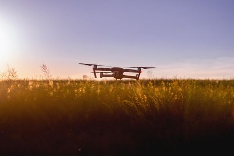 Hexacopter drone hovering against a cloudy sky during a flight test Hexacopter drone hovering against a cloudy sky during a flight test